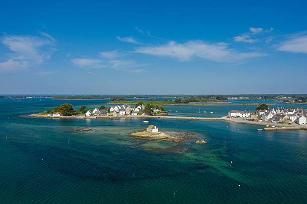 istock Tiny island house and clear tidal waters, Etel 2254937702