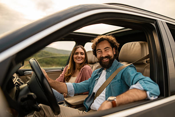istock Happy couple driving on a road trip adventure 2254939285
