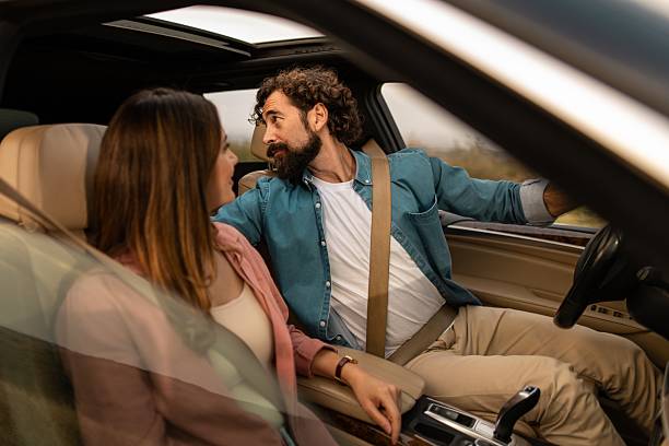 istock Couple driving car talking on road trip adventure 2254941467