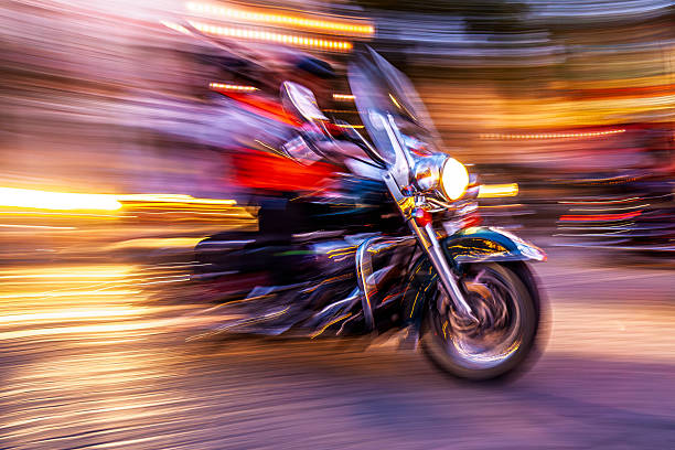 Custom motorbike streaks past, capturing raw speed in a blurred nightscape. Intense motion and street lights depict a dynamic, powerful ride.