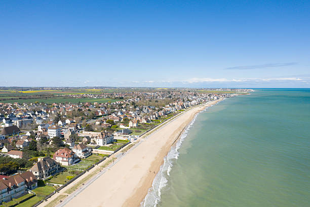 istock Sunny coastline and village at Sword Beach 2254941579