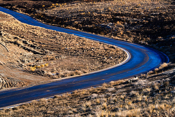 Freshly constructed road, curving through hills and mountains.