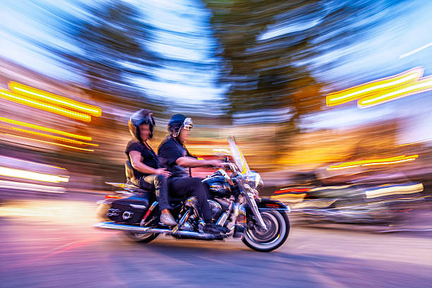Motorcyclists speed through the street on custom bikes, capturing dynamic motion with panning shot and a nostalgic, energetic feel.
