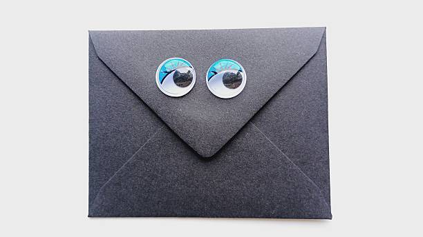 istock Valentine's Day love letter. Black envelope on a white background. Funny plastic eyes. 2254943140