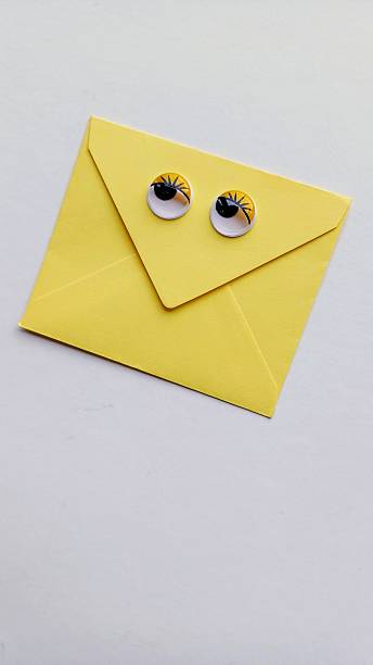 istock Valentine's Day love letter. Yellow envelope on a white background. Funny plastic eyes. 2254943191