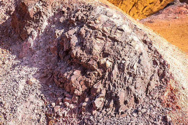 Eroded bauxite rock formation with bright orange colors in an abandoned bauxite mine