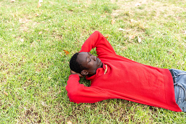 istock Young African man relaxing outdoors in nature, finding peace and leisure time 2254948132