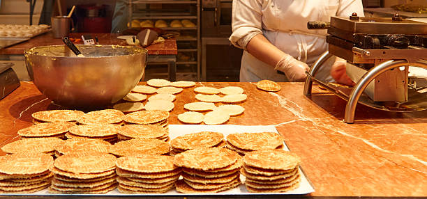 istock Belgian waffles preparation process with chef in kitchen, showcasing batter, waffle maker, and finished waffles 2254950208