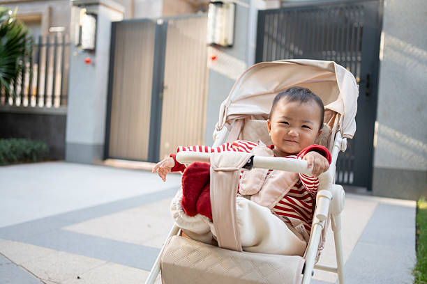 The baby sat in the stroller and laughed happily