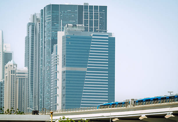 Dubai skyline featuring sleek glass towers and an elevated rail, conveying a futuristic urban landscape. The image captures modern architecture, city life, and ambitious development in the United Arab Emirates.