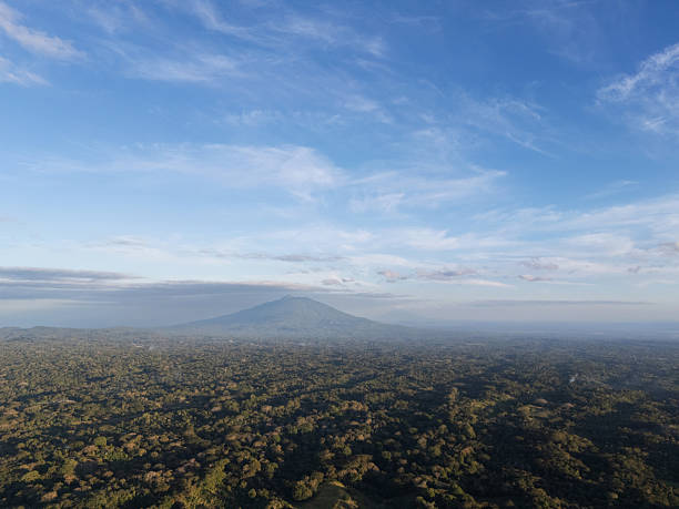 istock Mountains and forest landscape with blue sky and clouds during day 2254953424