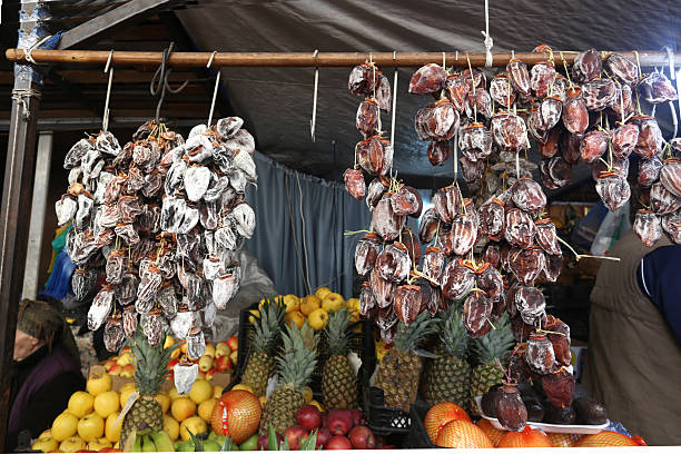 Dried persimmons on open market (bazaar) in Georgia  hanging (people iout of focus)