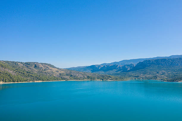 istock Vast turquoise lake with mountain backdrop 2254955707