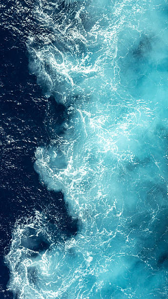 Ocean water showing deep blue and foamy turquoise waves mixing