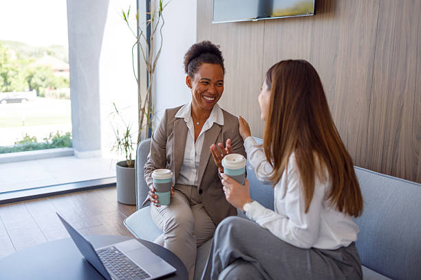 istock Diverse businesswomen discussing during coffee break in modern office, sharing ideas and smiling 2254956264
