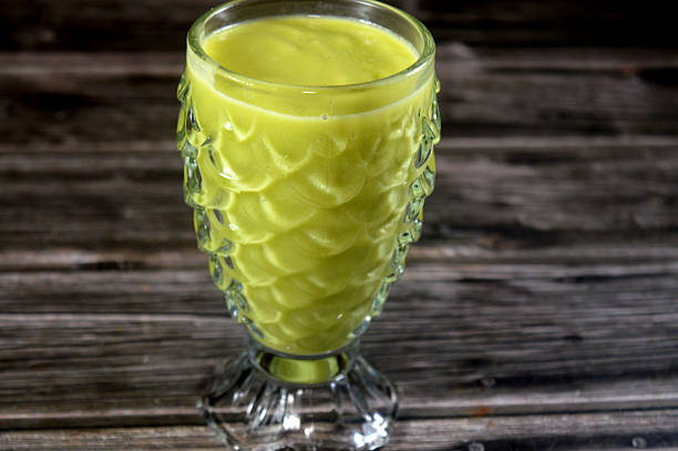 A glass of fresh avocado Juice, a nutrient dense fruit, botanically a large berry, known for its creamy texture, healthy fats primarily monounsaturated, fiber, vitamins, and minerals