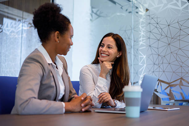 istock Two female entrepreneurs having a cordial conversation, sharing smiles and collaborating in a contemporary office setting 2254957151