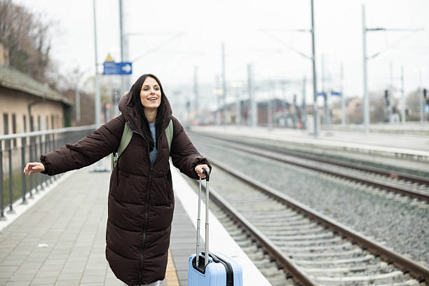 istock Waving traveler with suitcase 2254958337