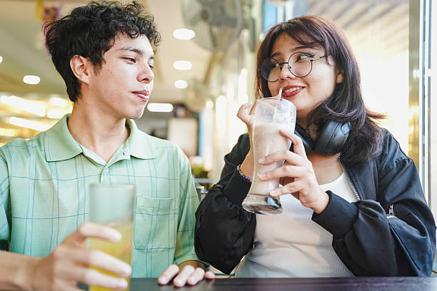 istock Young couple enjoying drinks together on a cafe date 2254958939