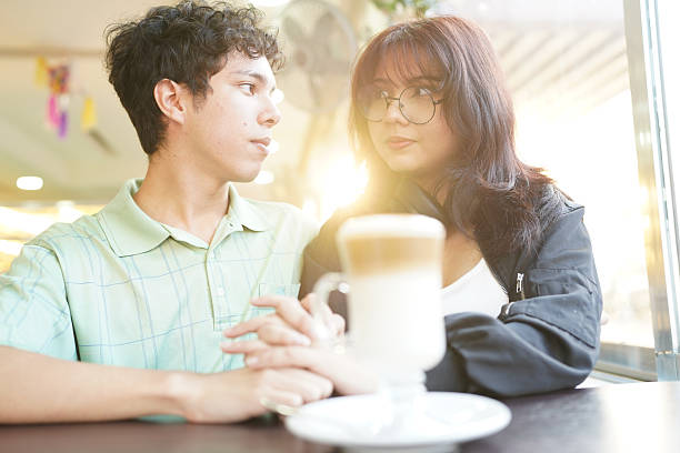 istock Young couple holding hands enjoying coffee date 2254958973