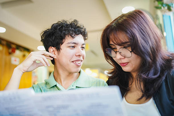 istock Smiling couple reading menu together on a date 2254959052