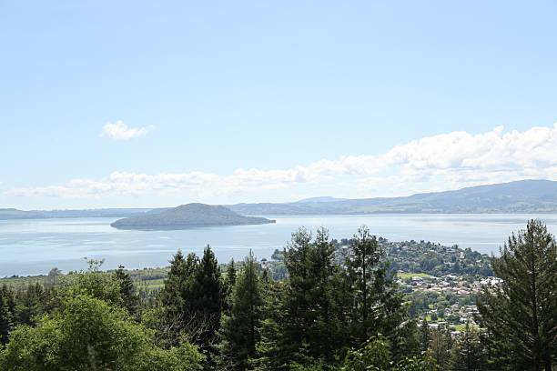 istock Sunny Lake Island Beyond Forested Hillside 2254960556