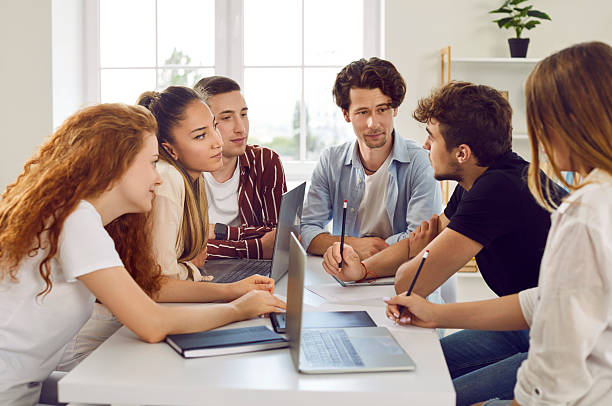 istock School, college or university students working on group project and discussing something 2254964134