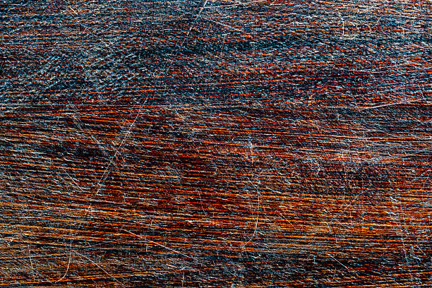 Background and texture of old scratched wood panel, close up, top view. Wooden rough surface