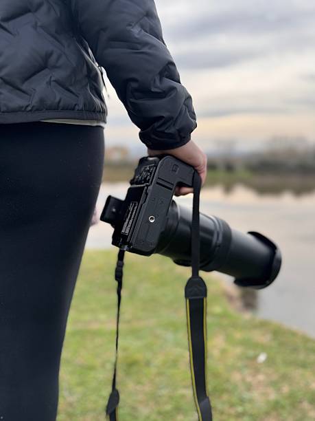 istock A woman's hand and camera doing nature photography. 2254966060