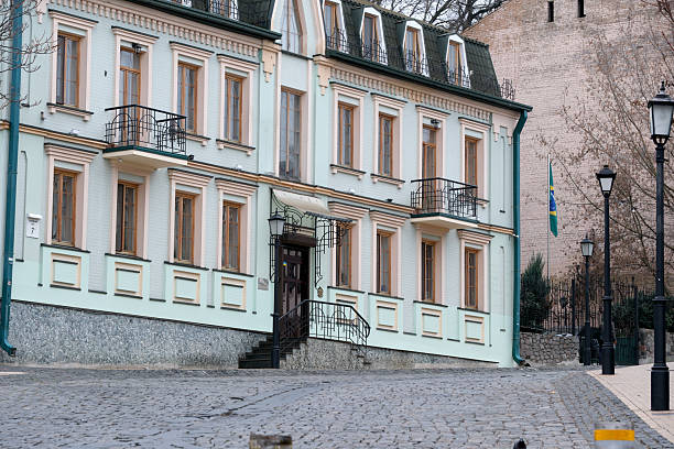 Beautiful architecture stands on a quiet cobblestone street, surrounded by nature. Andreevsky Uzviz, Kyiv, Ukraine. December 8, 2025.