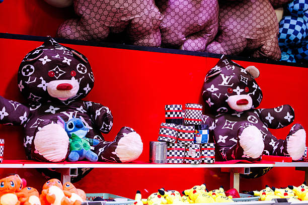 Villach, Austria - July 29, 2025: Plush teddy bears with designer patterns sit alongside colorful toys, creating a lively and festive atmosphere for visitors