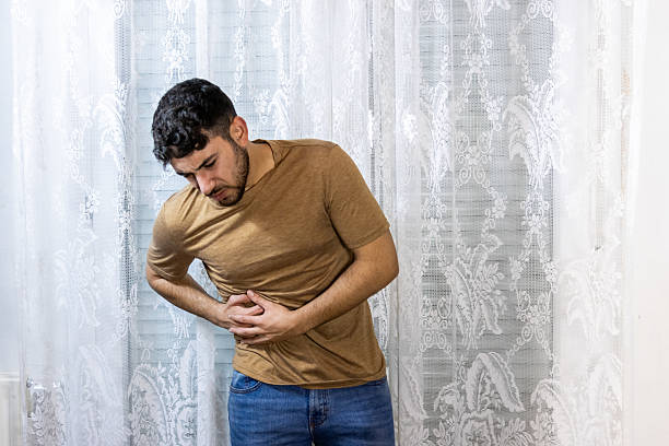istock Young man experiencing severe abdominal pain and stomach ache 2254972459