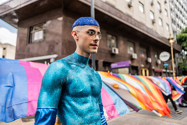 Activist in blue body paint at pride parade.