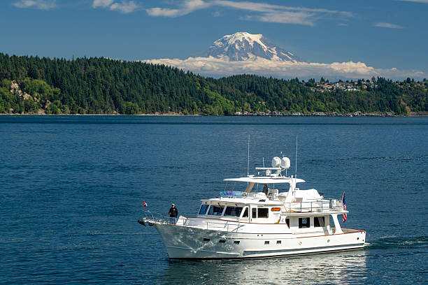 Gig Harbor, USA - August 8, 2025. Men on yacht sailing toward Gig Harbor, Washington, USA