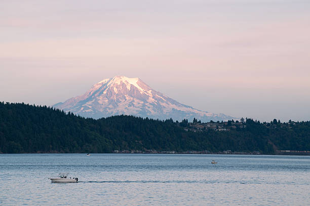 Gig Harbor, USA - August 8, 2025. Sailing at Puget Sound at Sunset with Mt Rainier in background, Gig Harbor, Washington, USA
