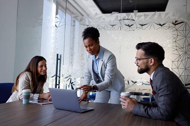 istock Diverse business team collaborating during meeting, female leader discussing strategy using laptop in modern office 2254978015