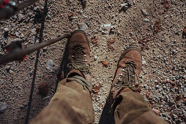 Details of trekking boots during a outdoor trekking in a natural forest environment. Shot in the Lepini Mountains, Lazio, Italy.