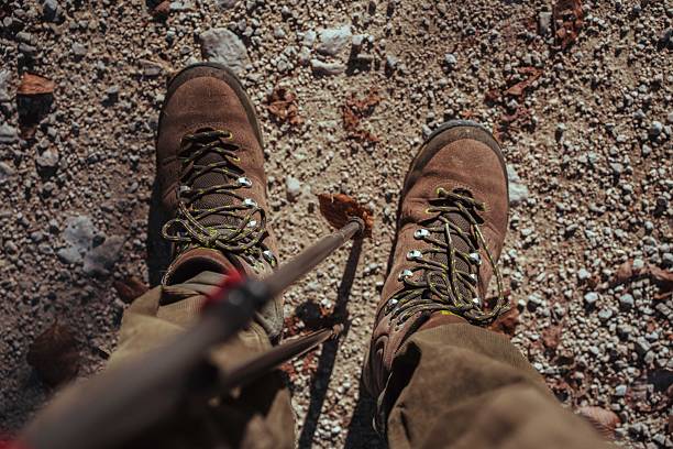 Details of trekking boots during a outdoor trekking in a natural forest environment. Shot in the Lepini Mountains, Lazio, Italy.