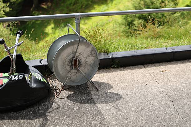 Outdoor track shows parked ride equipment asphalt barrier guardrail railing
