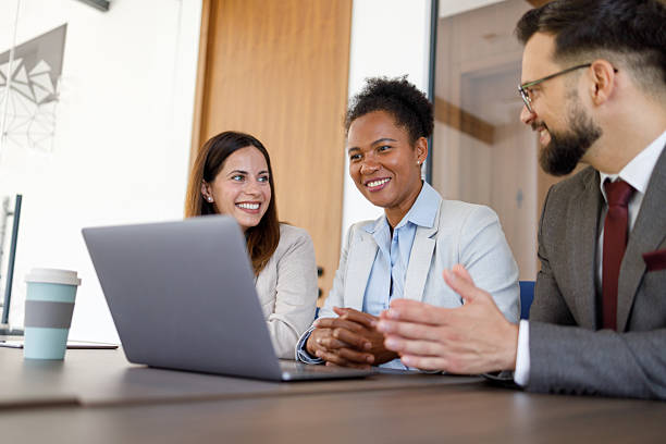 istock Diverse business partners collaborating, discussing project on laptop in modern office meeting 2254979009