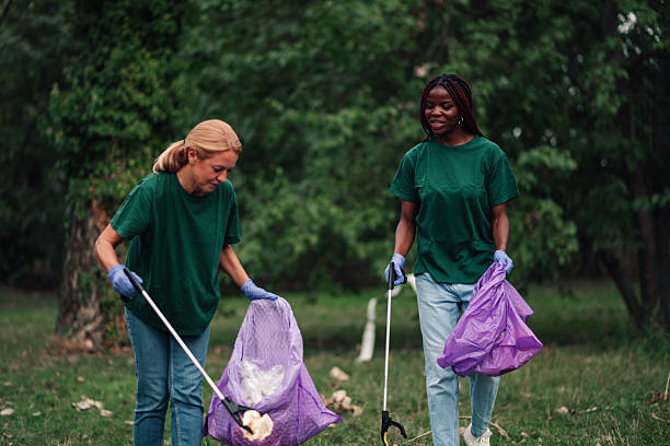 istock Women volunteers cleaning park, protecting environment 2254979432