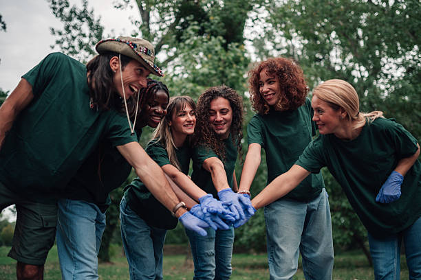 istock Diverse volunteers stacking hands showing teamwork and community support 2254979547