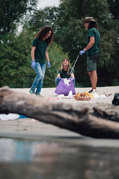 istock Young adults cleaning beach from plastic garbage pollution 2254979560