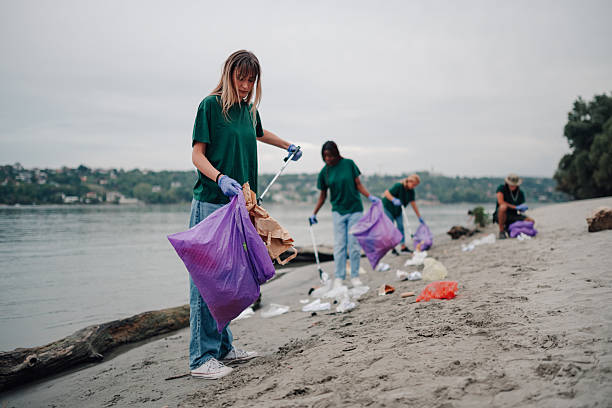 istock Volunteers cleaning riverbank, collecting plastic trash 2254979591