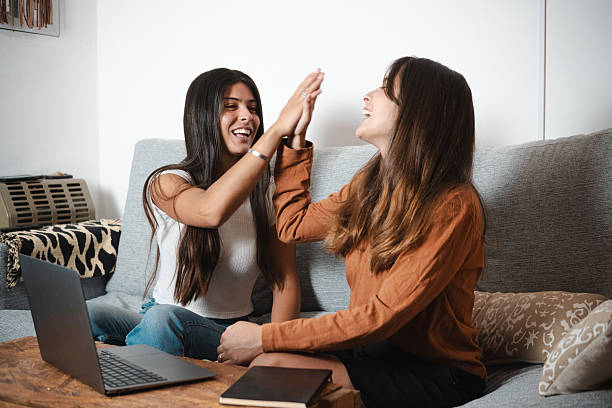 istock Two Young Women Celebrating Success with High Five at Home Office 2254979698