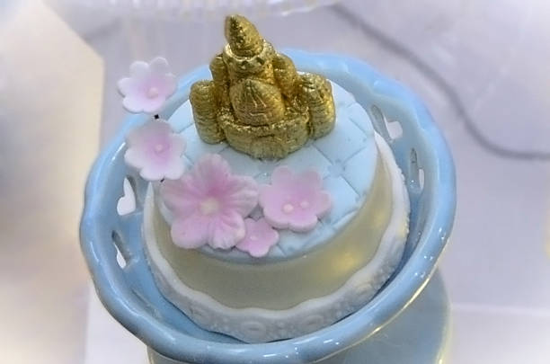 A personalized castle-shaped sweet treat decorated with flowers for a birthday party.