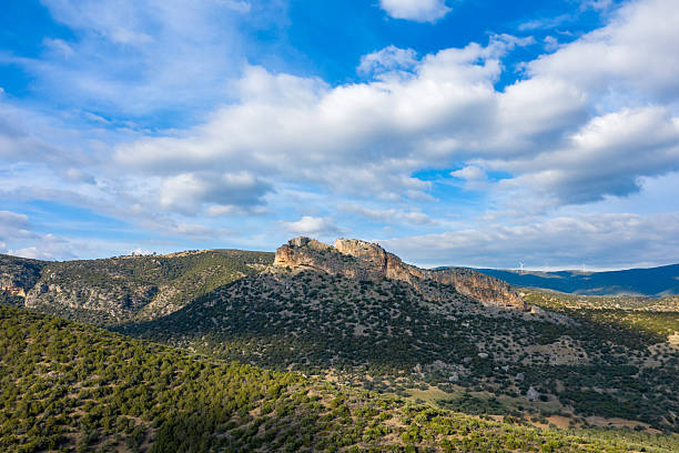 istock Rocky hilltop under dramatic sky in countryside 2254988880