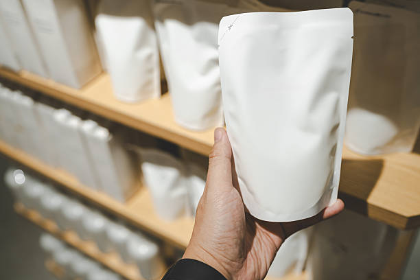 istock Hand holding a refill pouch in a zero waste retail store. Plastic waste reduction, and sustainable lifestyle choices. Eco conscious branding, zero waste, and marketing for sustainable consumer goods. 2254990666