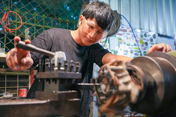 istock Machinist operating equipment workshop industrial process productive environment close-up perspective craftsmanship concept 2254992290
