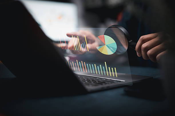 istock Analyzing Business Data on Laptop with Magnifying Glass 2254992712